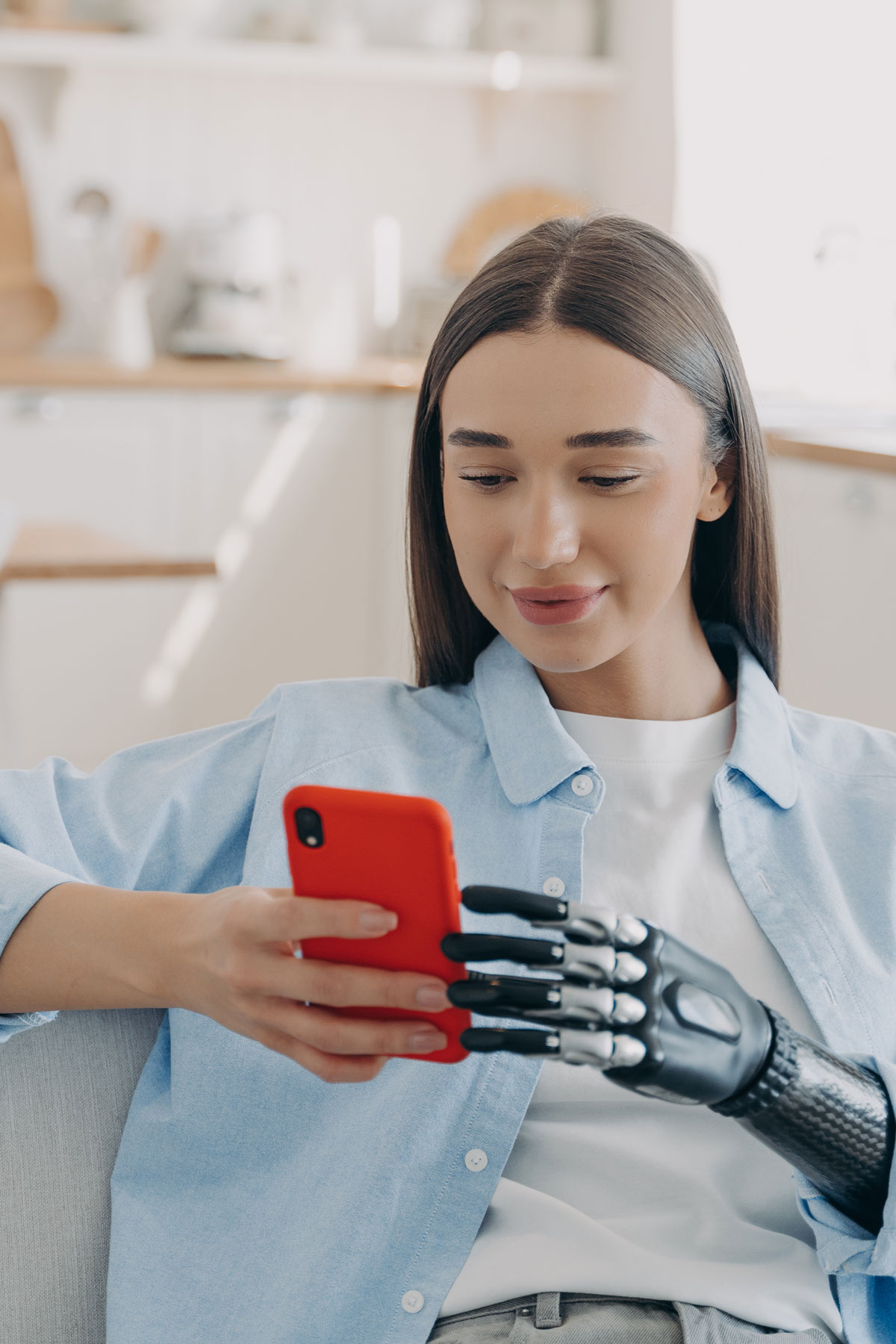 girl-with-disability-bionic-prosthetic-arm-holds-smartphone